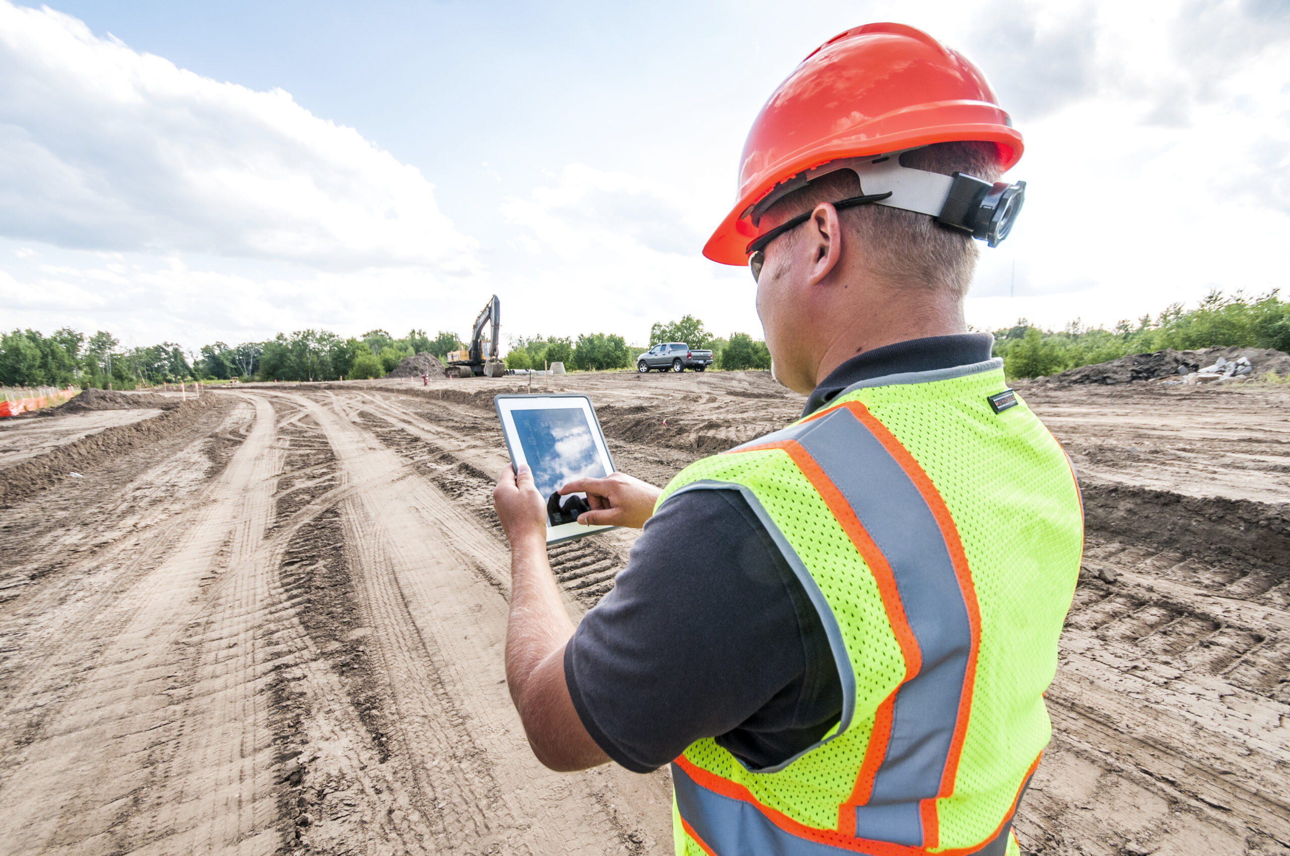 engineer with hardhat using tablet pc computer inspecting